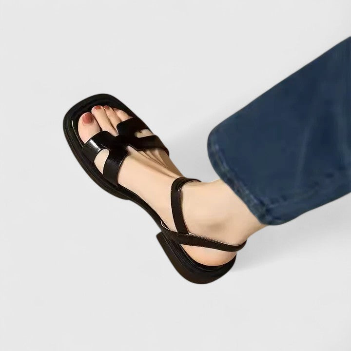 Stylish women's H-strap flat sandals featuring a modern cutout design & secure ankle buckle, perfect for summer.