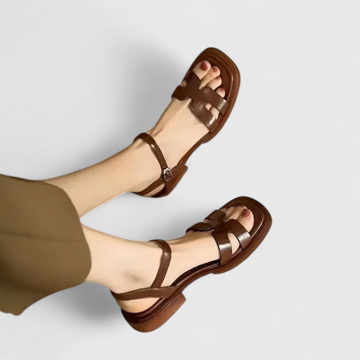 Versatile women's flat sandals with unique cutout H-strap design & functional ankle buckle closure. Summer essential.