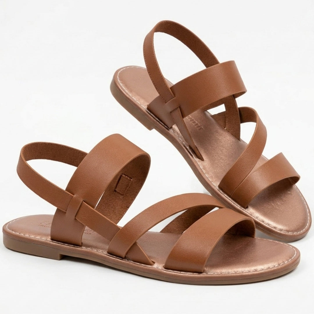 Women's flat sandals with stylish crossover straps & open toe design for effortless summer comfort.