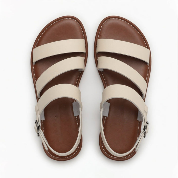 Vacation-ready women's flat sandals. Open-toe, crossover straps, and comfortable for exploring.