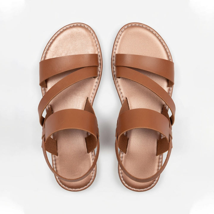 Slip-on women's flat sandals with crossover straps, perfect for vacation, beach, or summer outings.