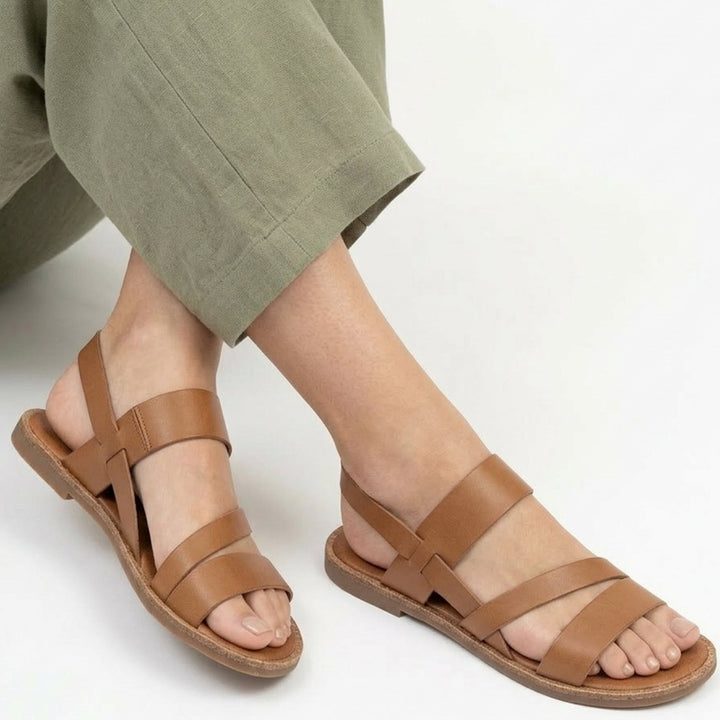 Women's summer flat sandals with comfortable crossover straps; great for casual or vacation wear.