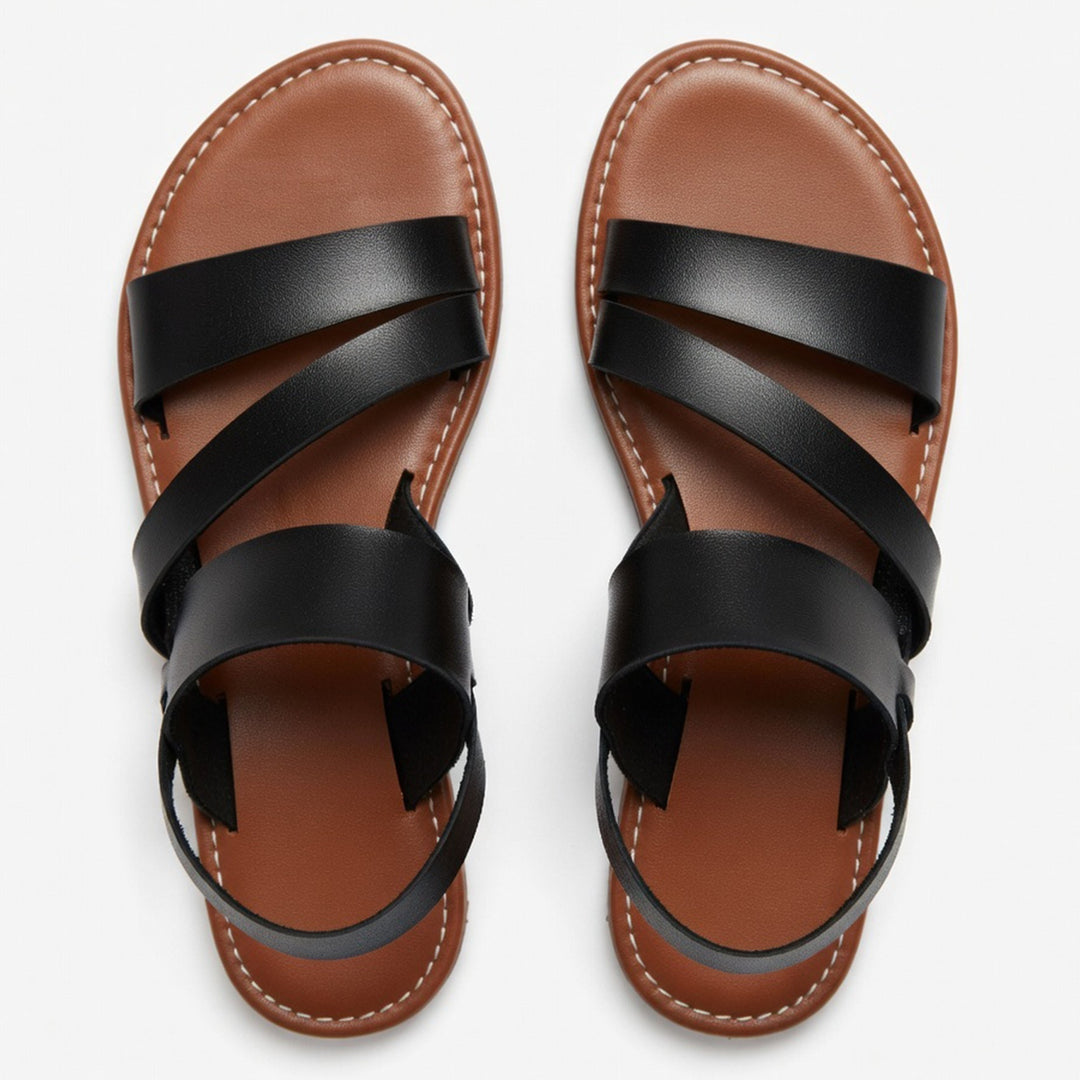 Stylish slip-on women's flat sandals with crossover straps, perfect for warm weather fashion.