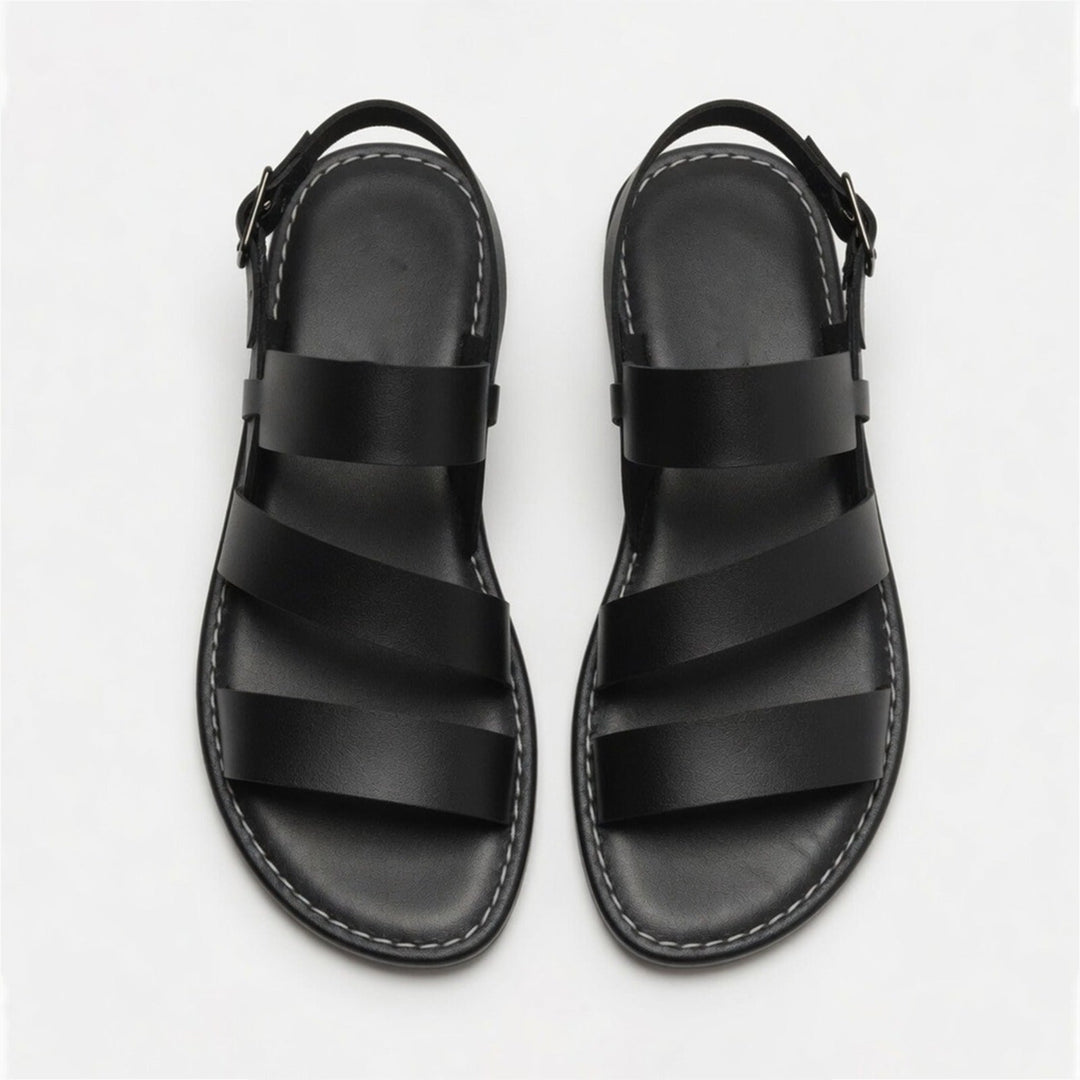 Comfortable women's flat sandals with open toe and crossover straps; versatile for summer footwear.