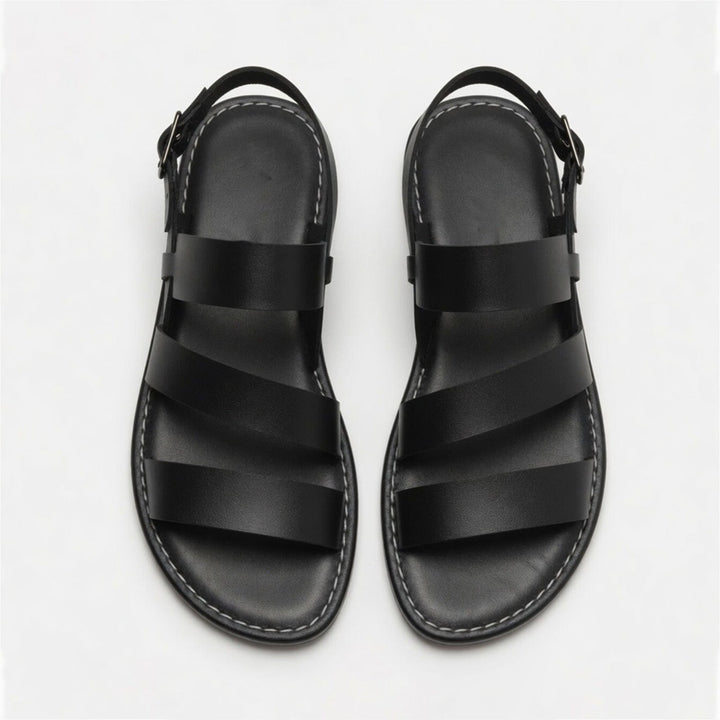 Comfortable women's flat sandals with open toe and crossover straps; versatile for summer footwear.