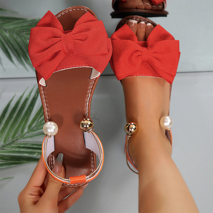 Comfortable women's flat sandals with elegant bow & bead details. Casual yet sophisticated summer footwear.