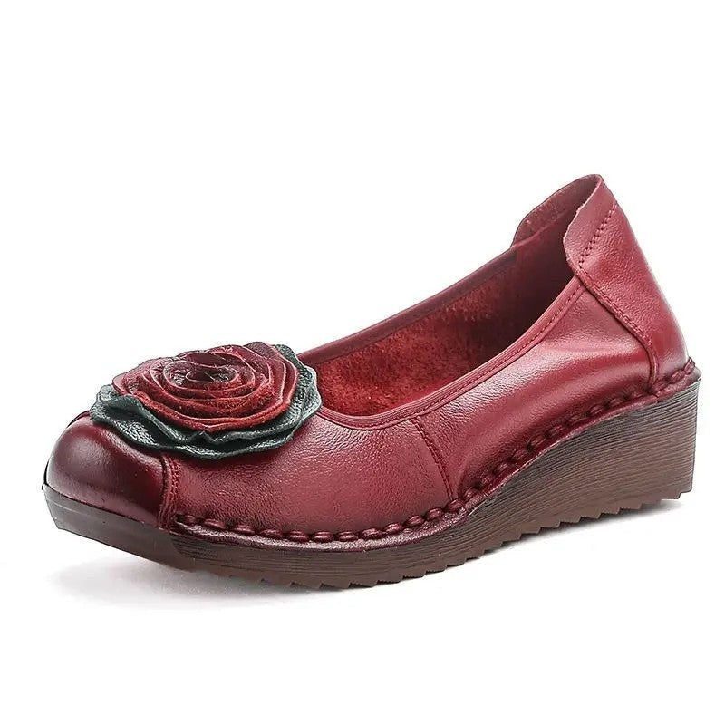 Premium women's slip-on loafers with exquisite floral appliqué detail.