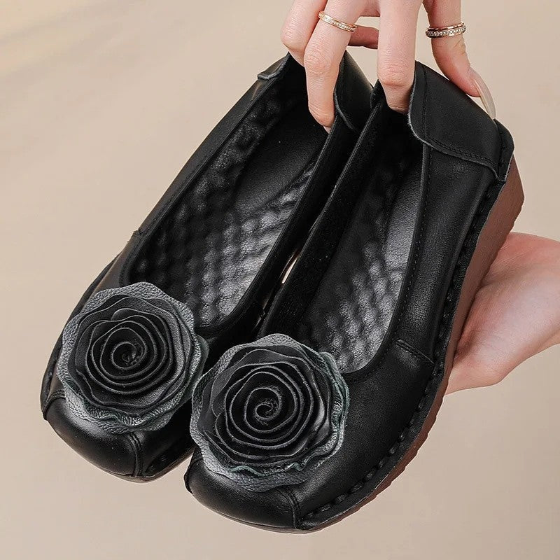 Comfortable women's slip-on loafers with elegant floral appliqué design.