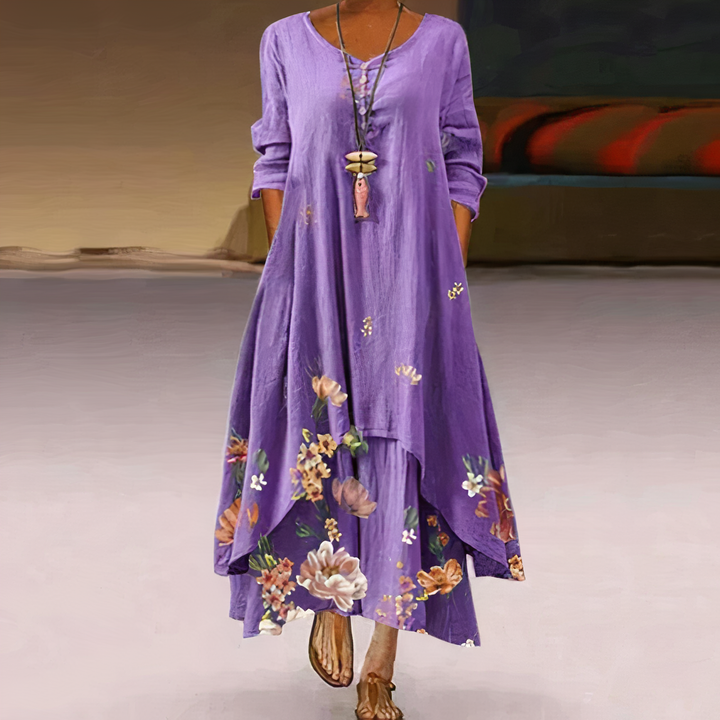 Boho-style V-neck floral maxi dress with long sleeves & border print, perfect for summer.