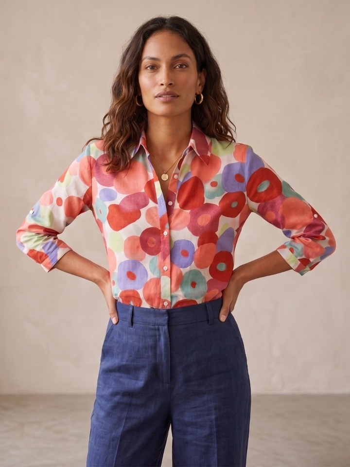 Women's floral button-down blouse with roll-tab sleeves, relaxed fit for versatile spring/summer casual wear.