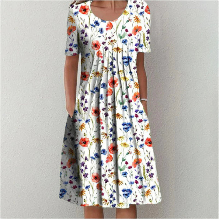 Women's floral casual midi dress with short sleeves, A-line cut, round neck & pockets. Perfect summer day dress.