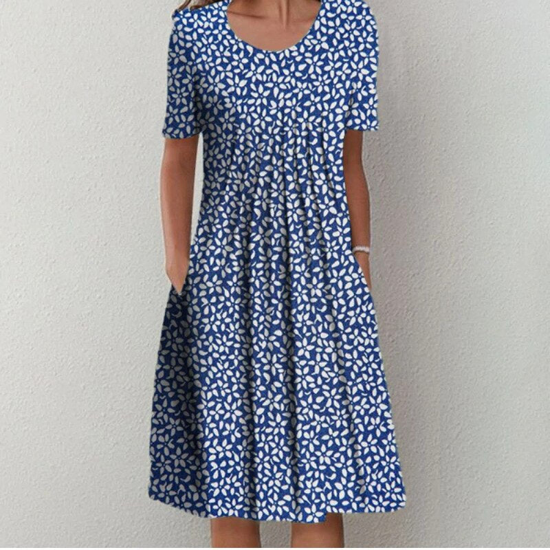 Front view of a women's floral casual summer dress. Midi length, short sleeves, round neck & convenient pockets.