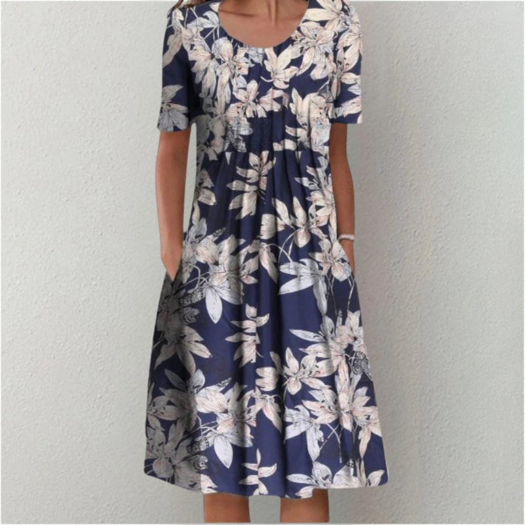 Chic women's floral summer dress. Casual A-line midi with short sleeves, round neck, & essential pockets for comfort.