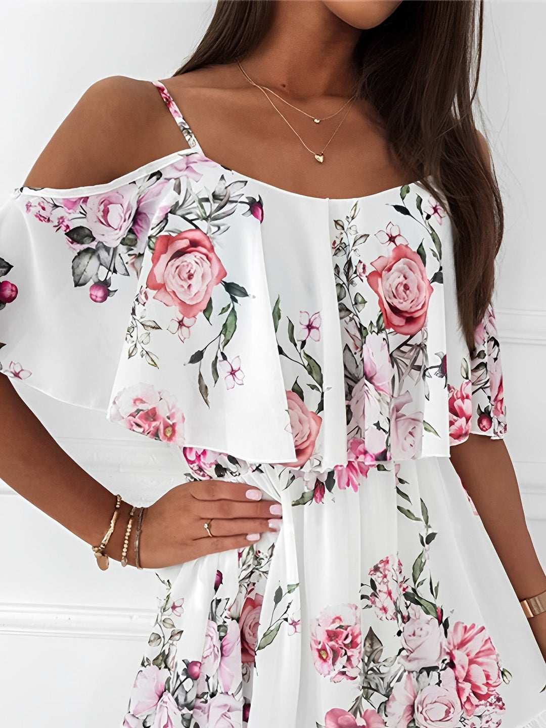 Flowy floral mini dress for women featuring chic cold shoulder design and delicate ruffle details.