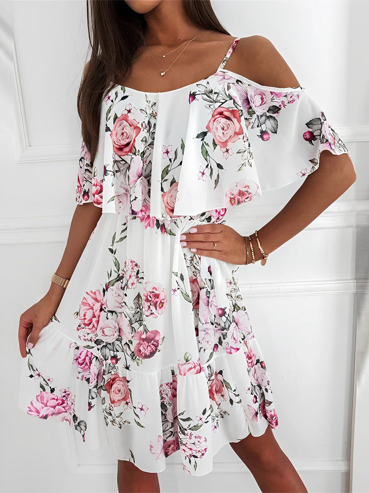 Elegant women's cold shoulder mini dress in a vibrant floral print with stylish ruffle trim.