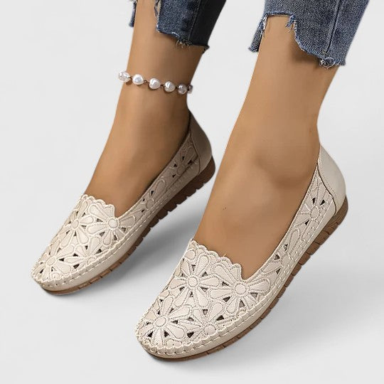 Versatile women's slip-on ballet flats with a perforated floral cutout. Round toe, comfortable for spring/summer casual wear.