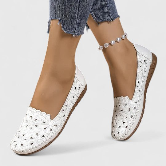 Comfortable women's perforated floral cutout ballet flats. Slip-on design for everyday elegance & casual summer wear.