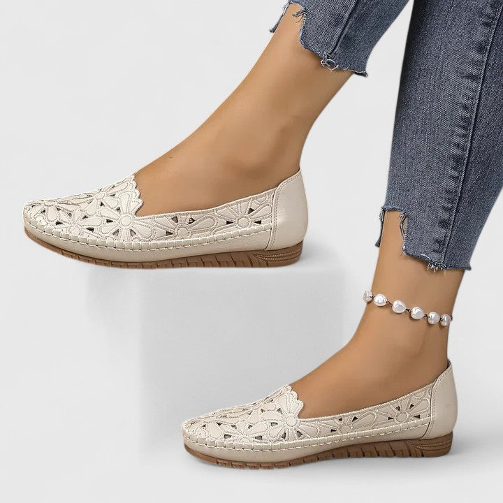 Lightweight women's perforated ballet flats featuring a beautiful floral cutout design. Ideal slip-on shoes for spring.