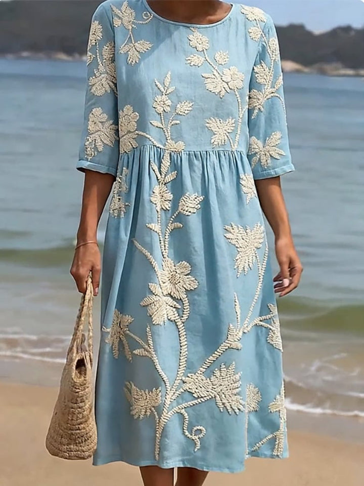 Lightweight women's flowing maxi dress featuring vibrant floral embroidery. Perfect for casual summer vacation outfits.
