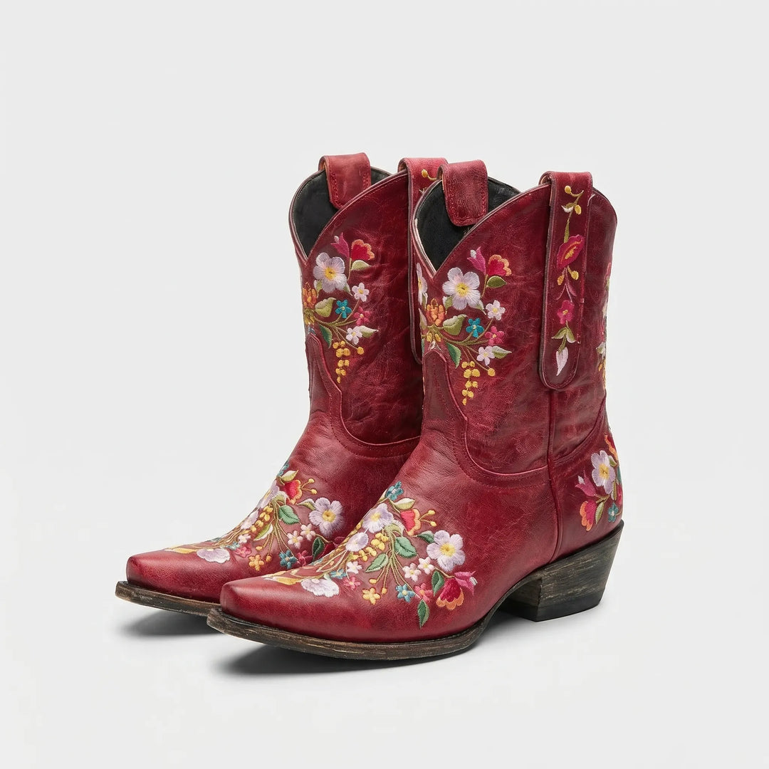 Fashion-forward women's cowboy ankle boots with bold floral embroidery, perfect for festival fashion.