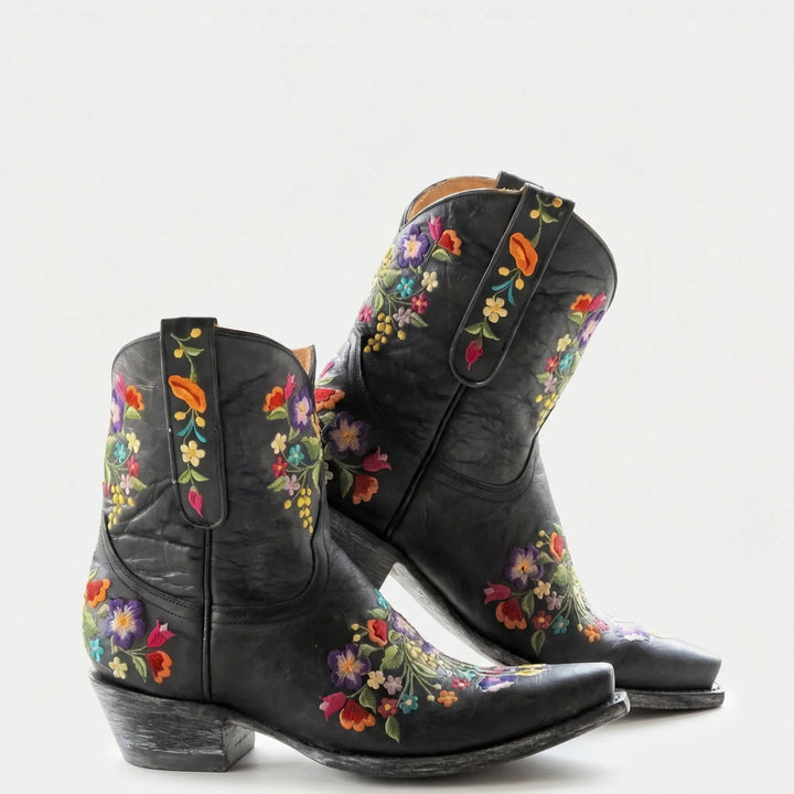 Comfortable women's floral embroidered western ankle boots featuring a pointed toe and sturdy block heel.