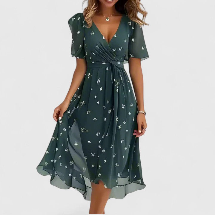 Detailed view of women's floral midi dress, showcasing flutter sleeves, v-neck, and vibrant print for elegance.