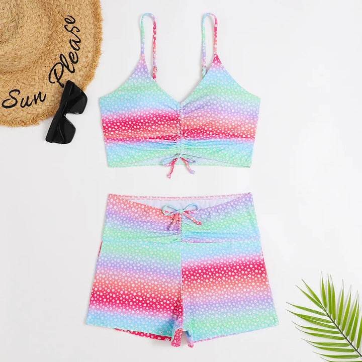 Woman relaxing by the pool in a floral high-waist supportive bikini, perfect vacation swimwear.
