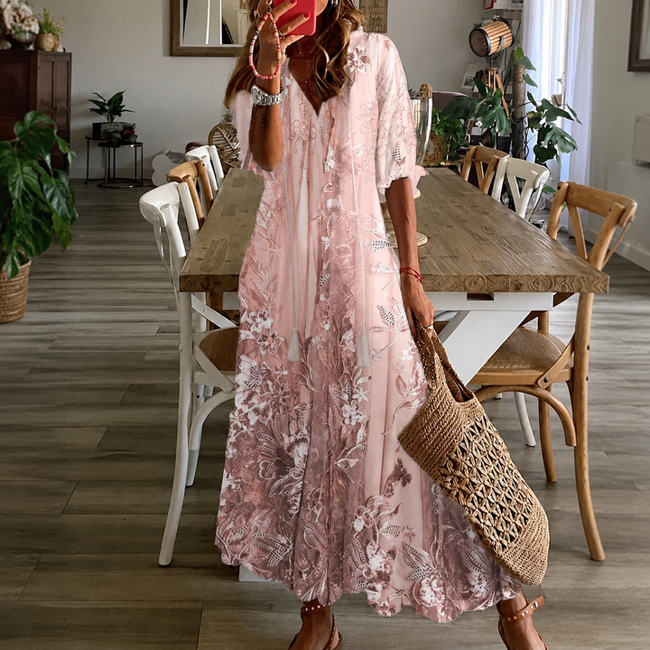 Women's floral maxi dress with split neck and half sleeves, perfect for summer garden parties.