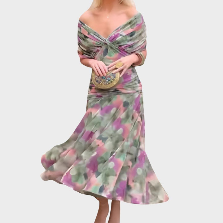 Women's floral off-shoulder maxi dress with long sleeves for ceremonies. Elegant and flattering evening gown.