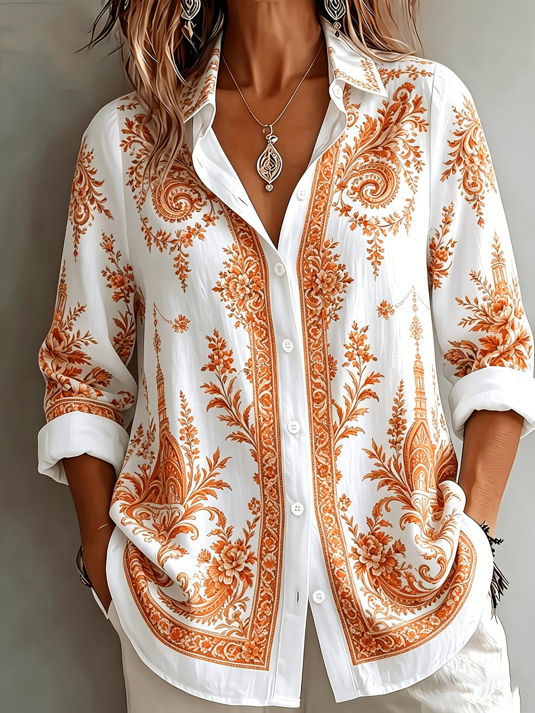 Spring fashion: women's oversized floral paisley print long sleeve button-down blouse.