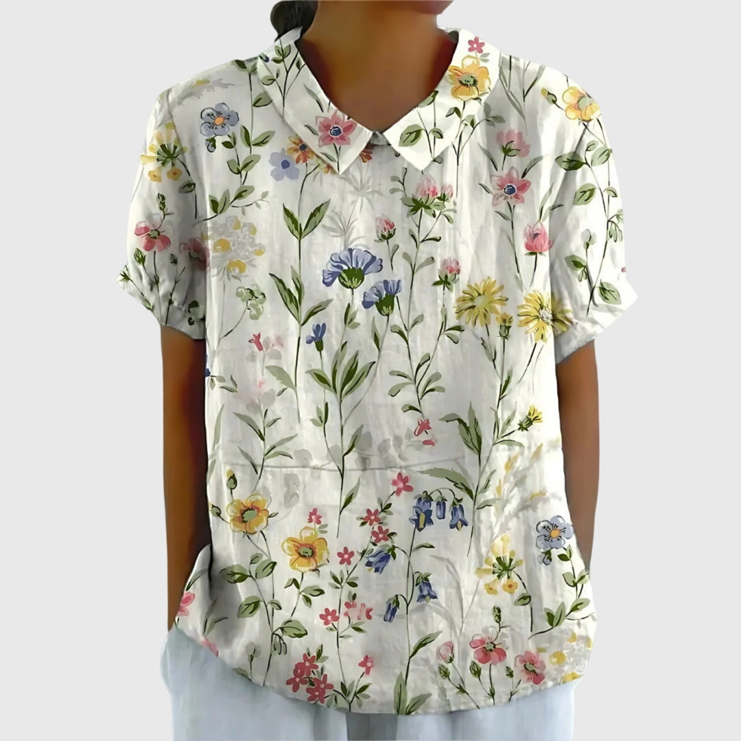 Women's floral print collared blouse. Relaxed fit, short sleeve, perfect for summer fashion.