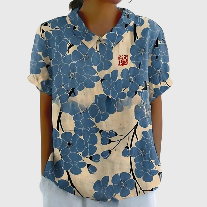 Charming floral print women's collared blouse. Relaxed short sleeve top, perfect for summer fashion.