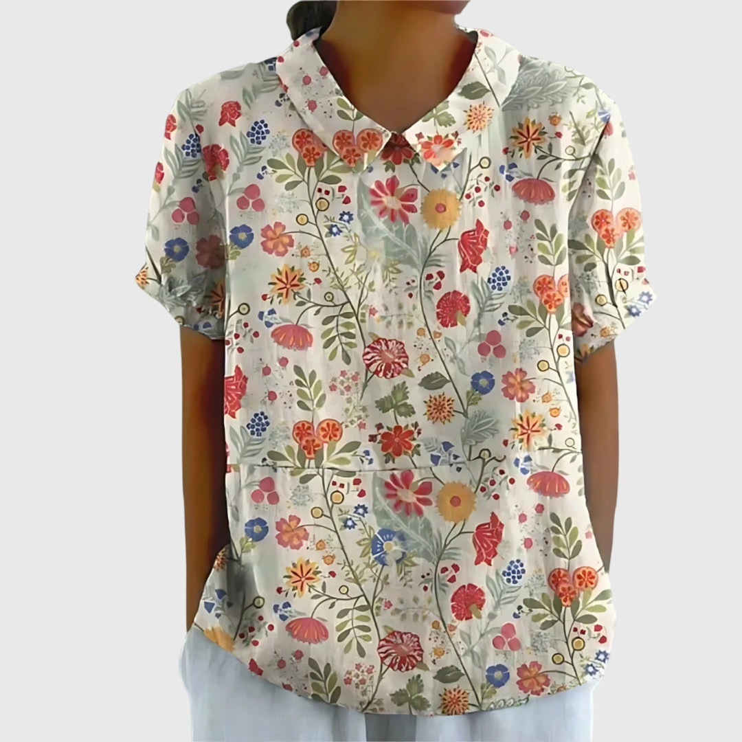 Vibrant floral print women's blouse. Short sleeve collared shirt, relaxed fit, summer essential.