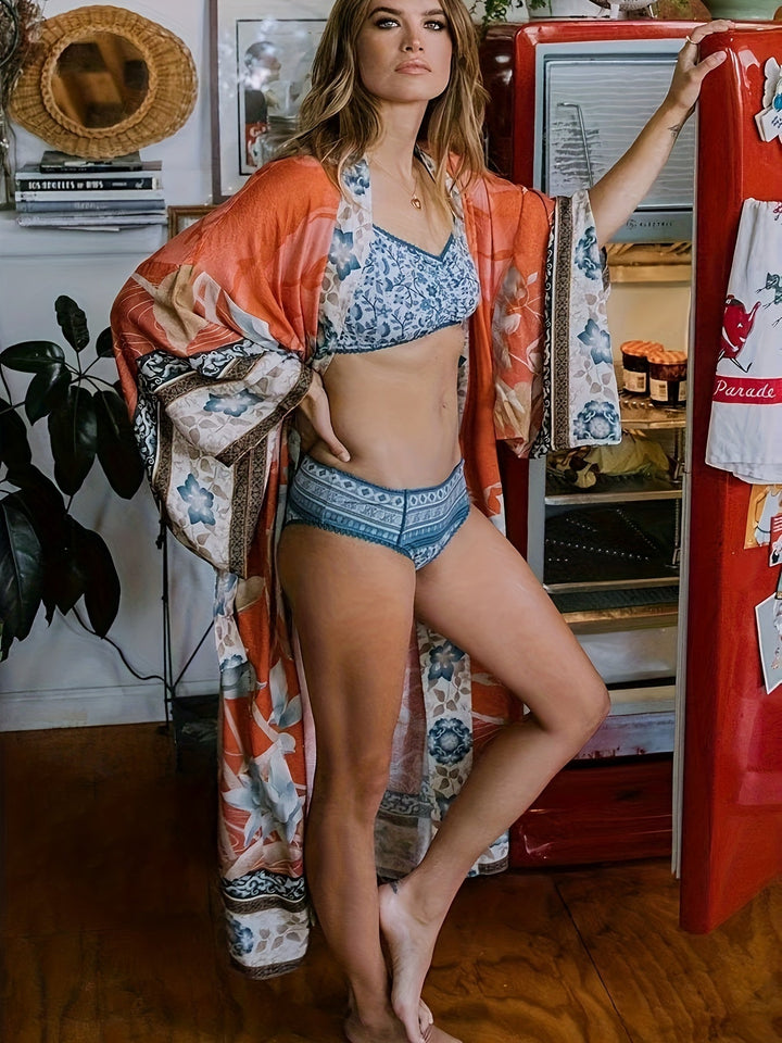 Lightweight open-front women's kimono with vibrant floral print. Stylish beach cover-up & resort wear.
