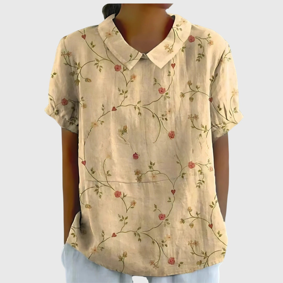 Detailed women's floral print short sleeve blouse with a distinctive collared neckline, chic & modern.