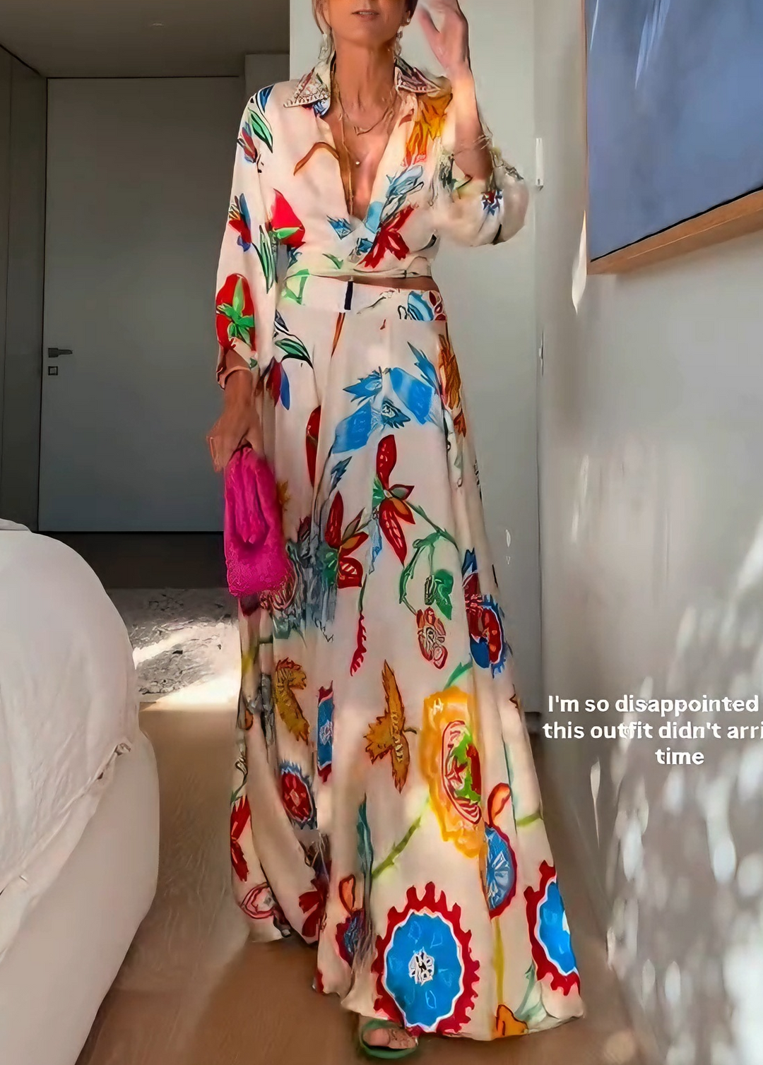 Woman wearing a vibrant floral print tie-front shirt and coordinating maxi skirt. Summer fashion.