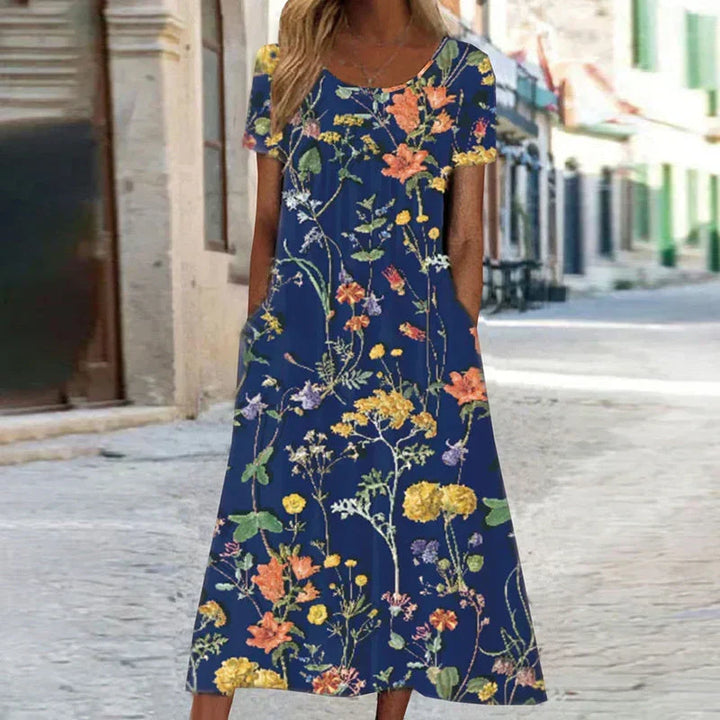 Women's floral short sleeve midi dress with vibrant print, ideal for summer and spring fashion. Casual elegant style.