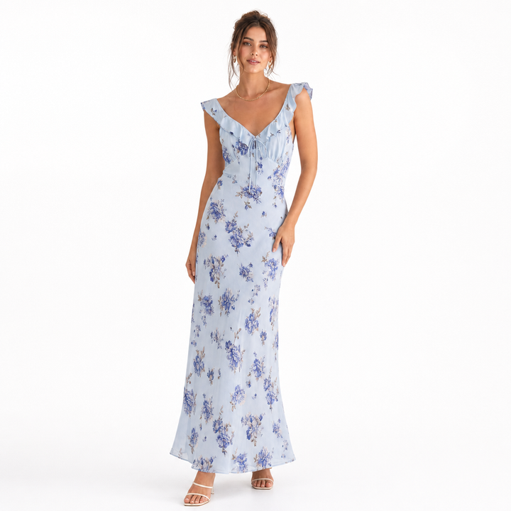 Woman enjoying the sun in a vibrant floral sleeveless backless summer beach dress. Perfect vacation outfit.
