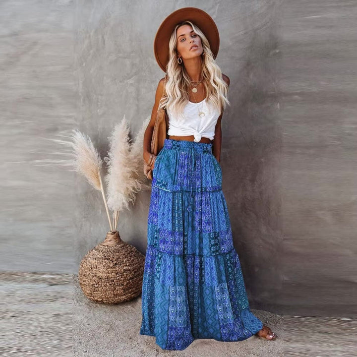 Detail shot of women's floral tiered maxi skirt, showcasing the elegant flowy fabric & summer pattern.