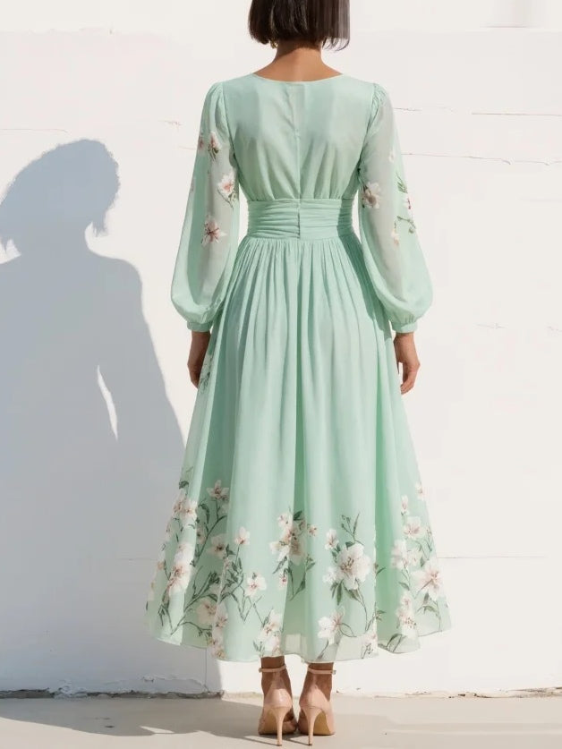 Elegant women's midi dress featuring a vibrant floral print, flattering V-neck, and chic long sleeves.