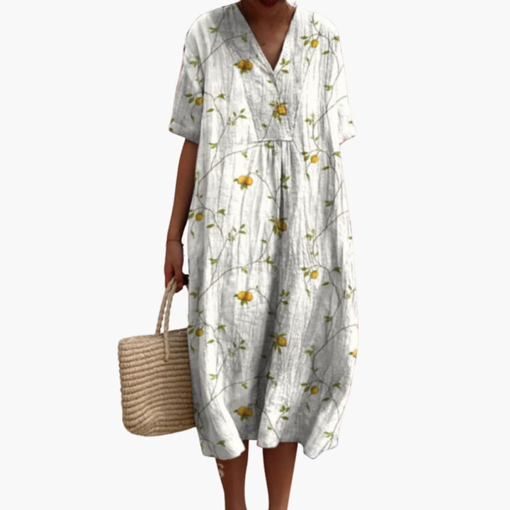 Versatile women's oversized floral midi dress. V-neck, short sleeves, and a flattering flowy design for summer.