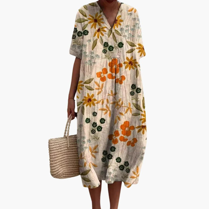 Women's short sleeve floral V-neck midi dress. Oversized, soft fabric, great for travel and casual fashion.