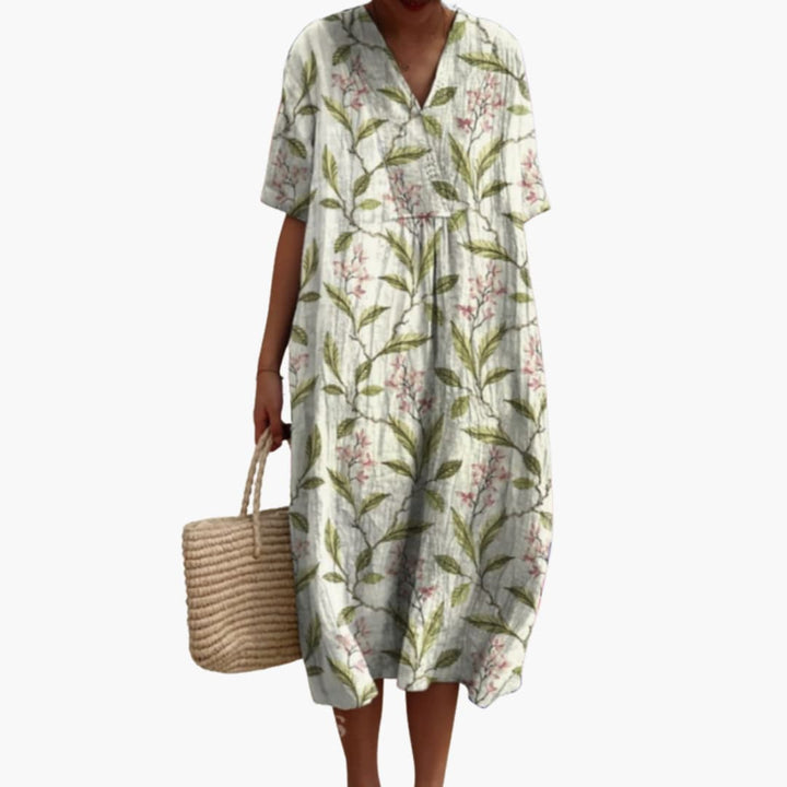Chic women's floral print V-neck midi dress. Oversized, short sleeve, perfect for vacation or everyday.