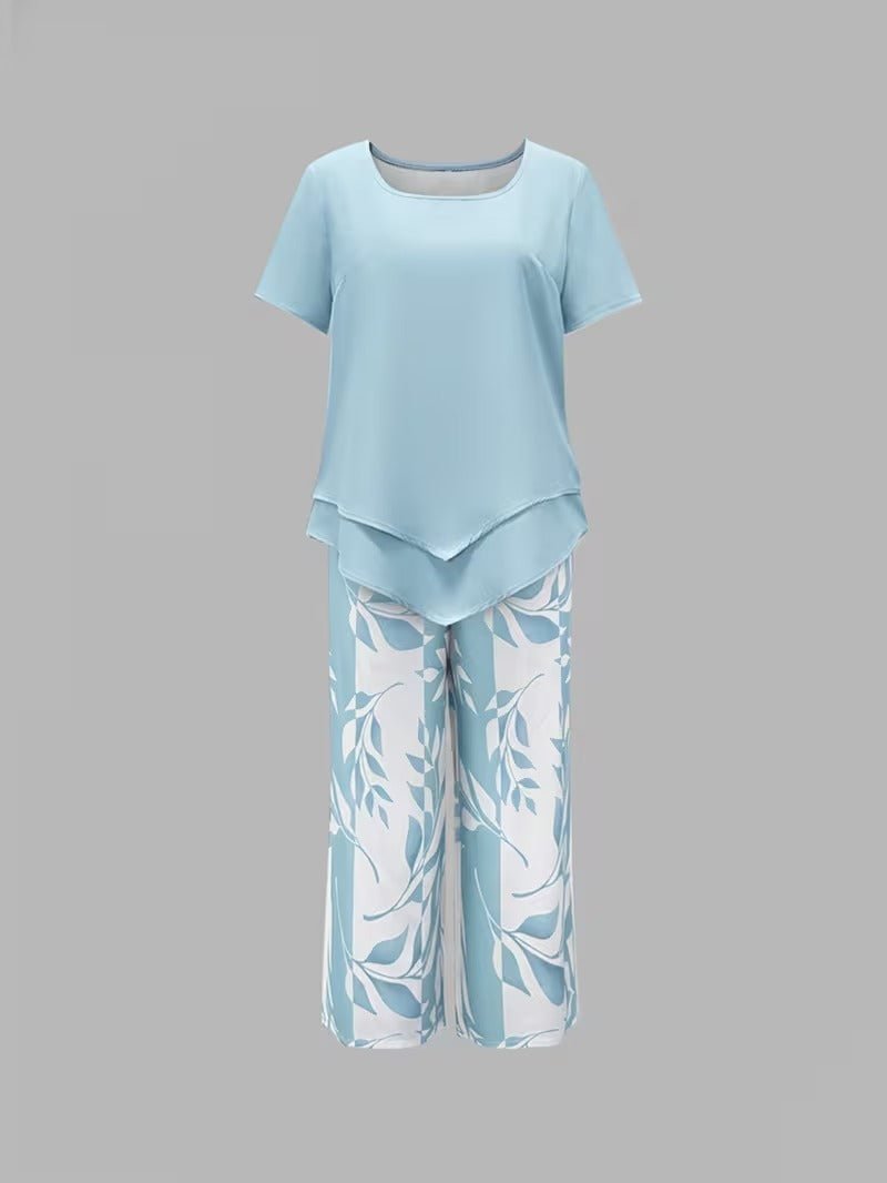 Woman models a comfortable floral V-neck top & wide-leg pant casual two-piece set for spring/summer style.