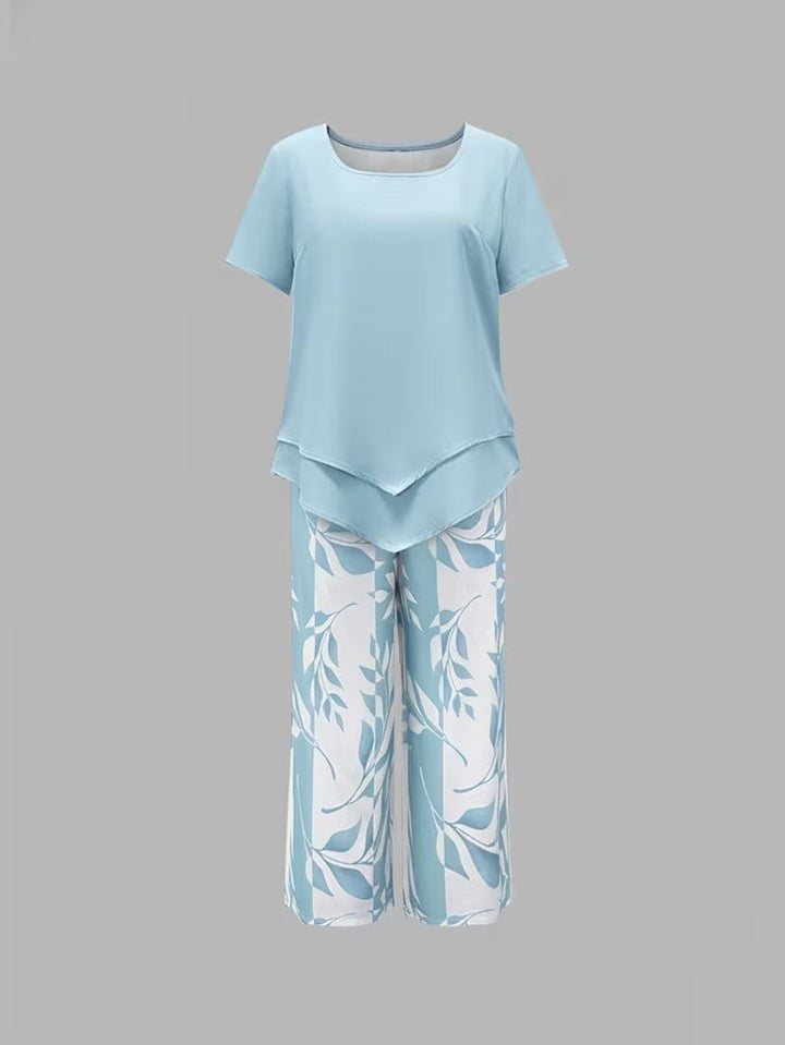 Woman models a comfortable floral V-neck top & wide-leg pant casual two-piece set for spring/summer style.