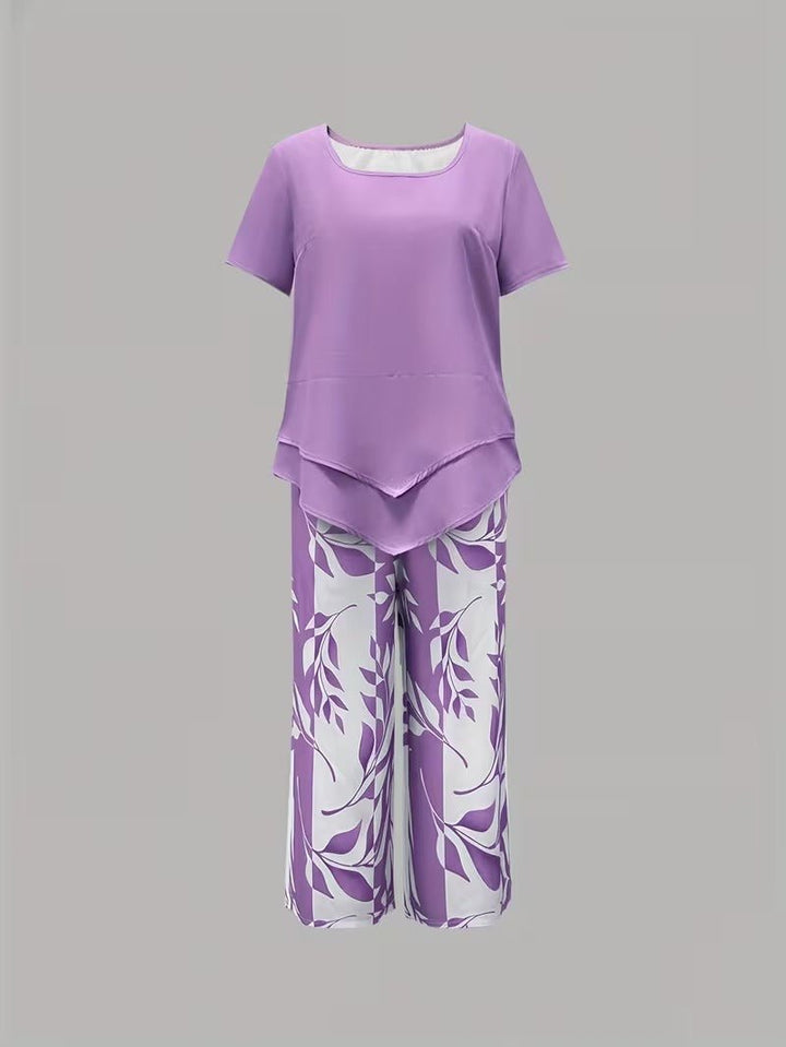 Vibrant floral print women's V-neck top & wide-leg pant set. Chic two-piece casual clothing for summer.