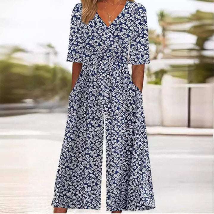 Women's V-neck floral wide leg jumpsuit featuring elbow sleeves & palazzo pants for an elegant look.