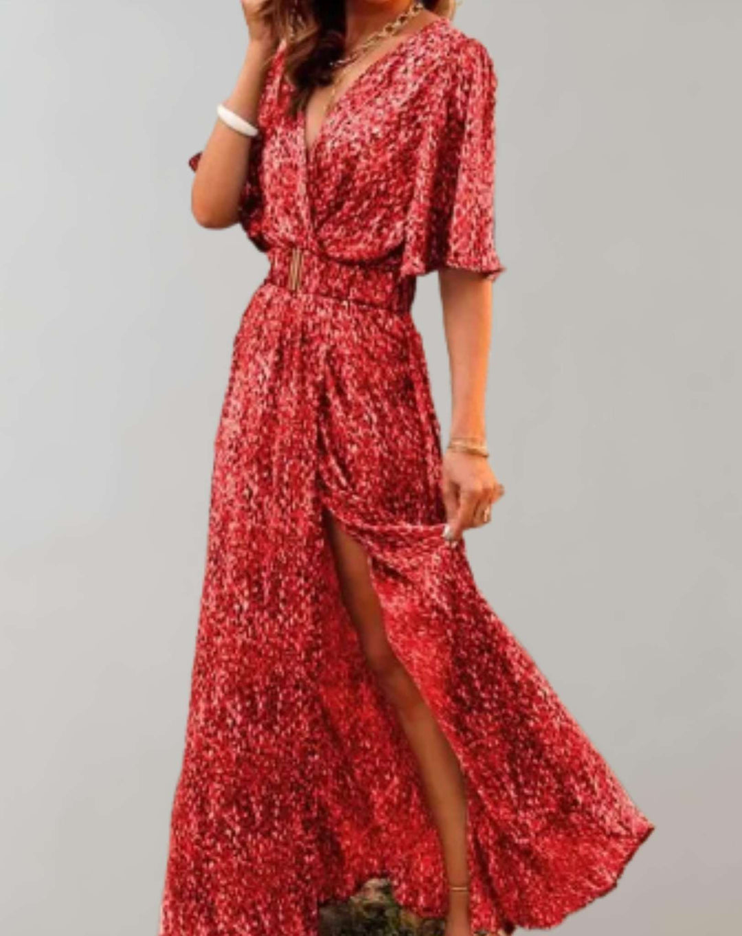Woman wearing a beautiful floral wrap maxi dress with side slit, perfect for a sunny summer day or outing.