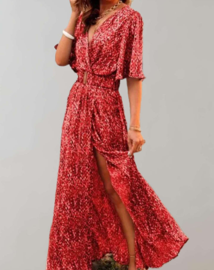 Woman wearing a beautiful floral wrap maxi dress with side slit, perfect for a sunny summer day or outing.