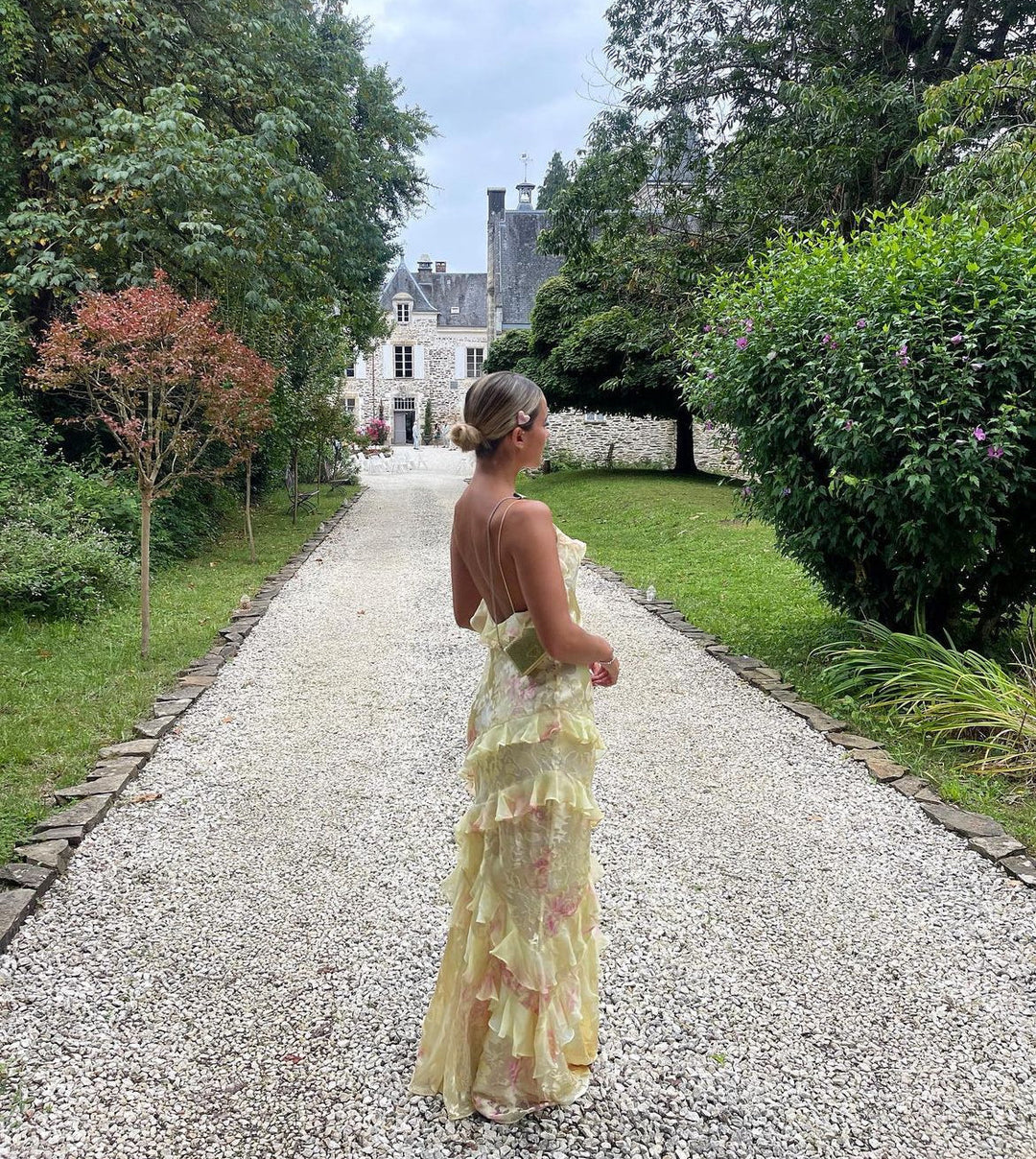 Stunning Women's Ruffle Maxi Dress with a chic open back. Perfect flowy evening gown for elegant events.